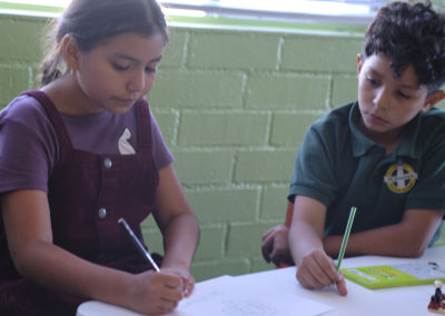 two kids drawing at educational program